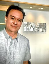 jim herr standing in front of a door with the national center for the preservation of democracy sign on the door